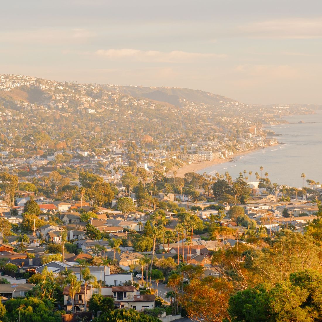Coastal hillside neighborhood above the beach at golden hour